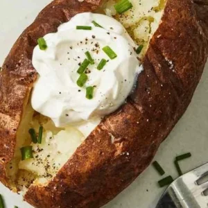 Air fryer baked potato served with toppings