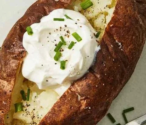 Air fryer baked potato served with toppings