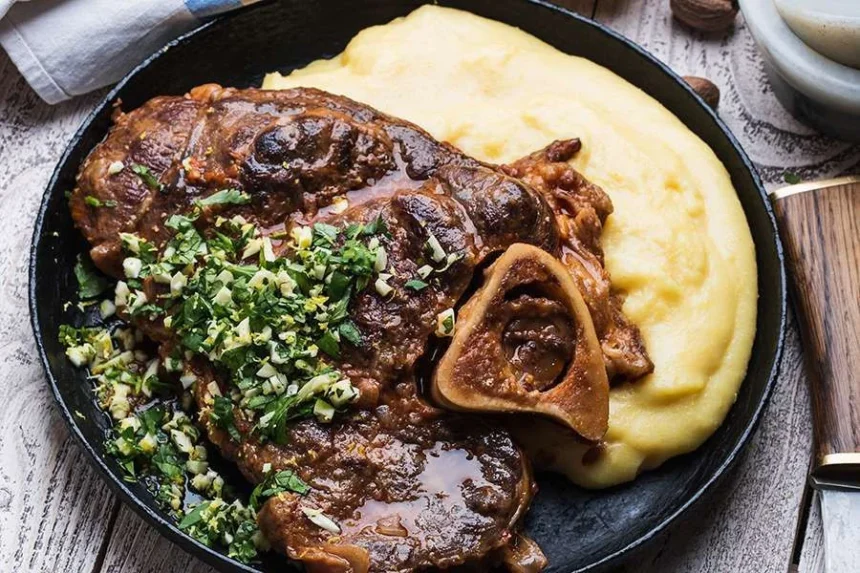 Deliciously braised veal shanks plated with fresh herbs and vegetables
