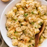 Bowl of classic potato salad with herbs and seasonings