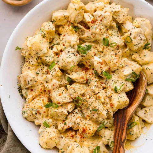 Bowl of classic potato salad with herbs and seasonings