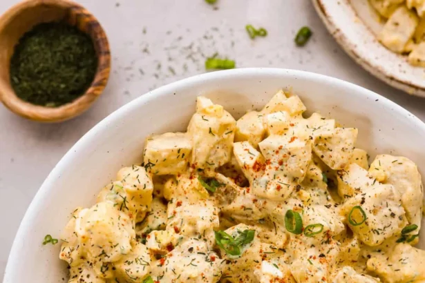 Bowl of classic potato salad with herbs and seasonings