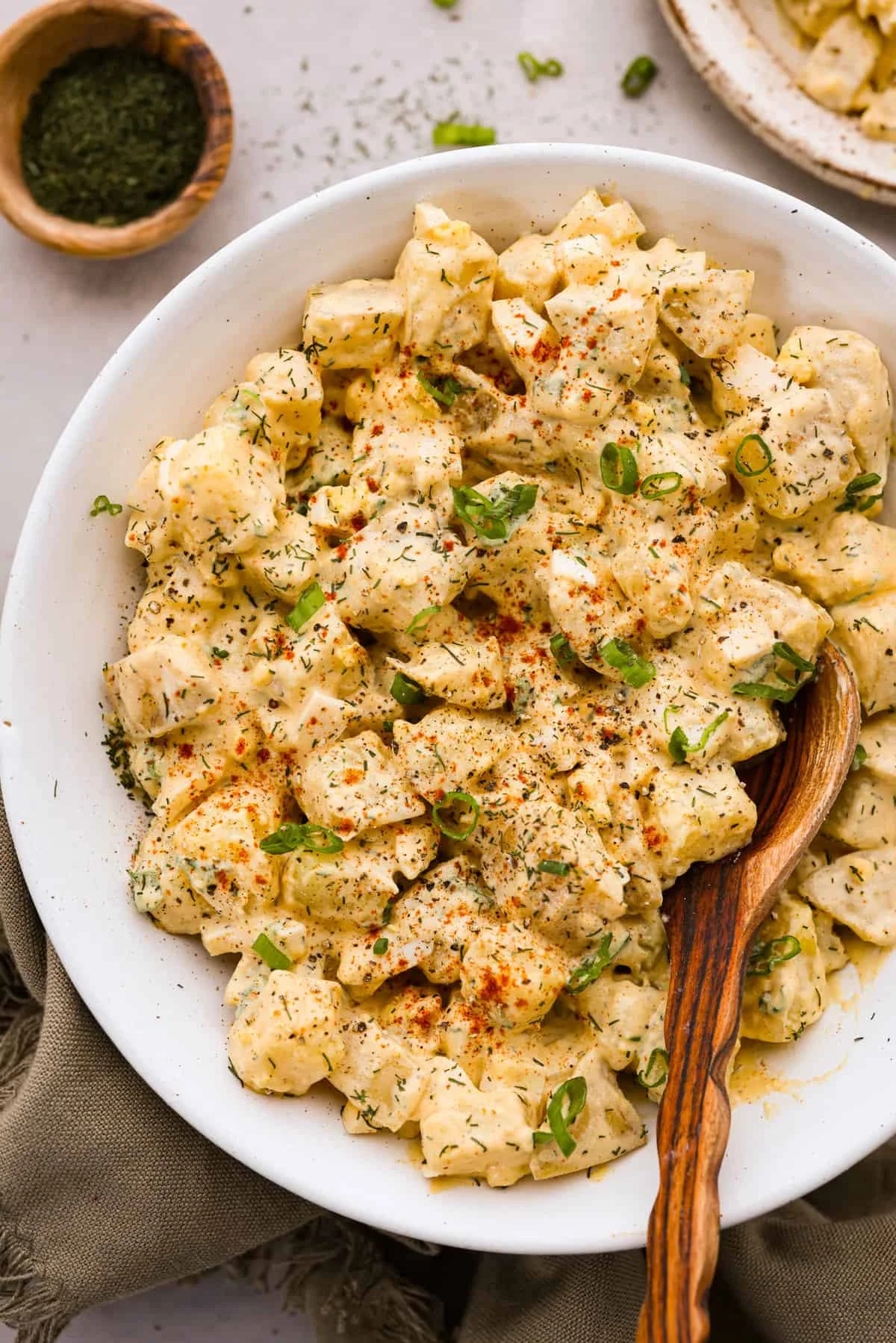 Bowl of classic potato salad with herbs and seasonings