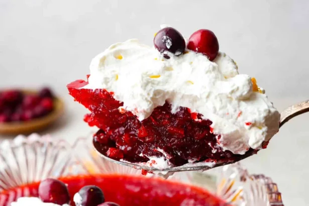 A colorful serving of Cranberry Jello Salad with cranberries and nuts