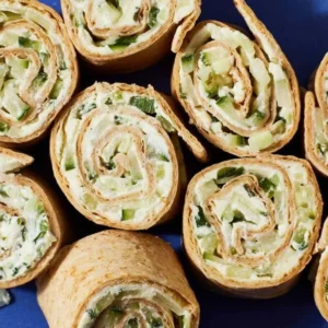 Cucumber Boursin Wrap on a plate with fresh herbs