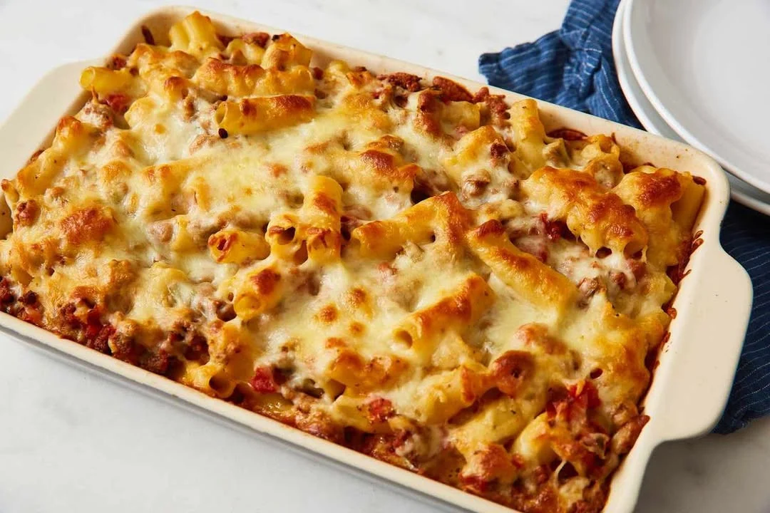 Baked ziti with cheese and marinara sauce served in a baking dish