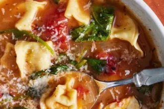 Bowl of easy Tortellini Soup with fresh spinach and herbs