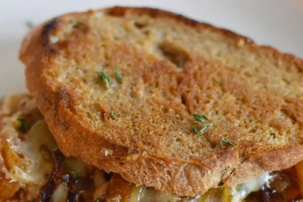 Delicious French Onion Soup Grilled Cheese Sandwich with melted cheese and onions