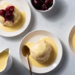 Delicious German yeast dumplings served with a creamy sauce