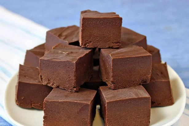 Delicious bowl of ice cream fudge topped with chocolate and nuts