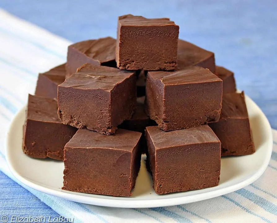 Delicious bowl of ice cream fudge topped with chocolate and nuts