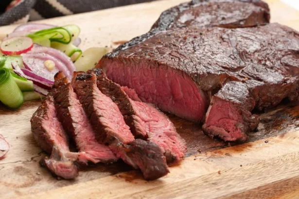 Marinated top round steak cooked to perfection on a grill.