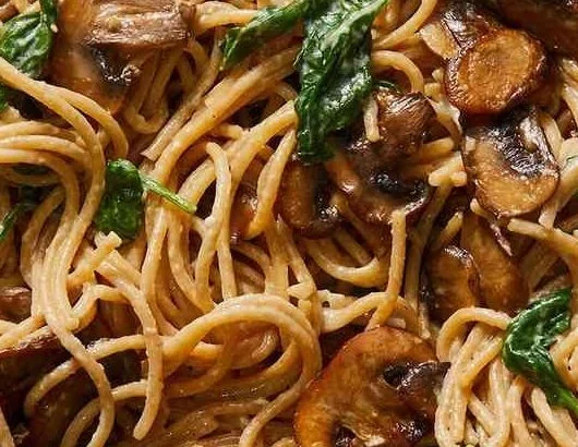 Delicious Mushroom and Spinach Pasta served in a bowl with fresh ingredients