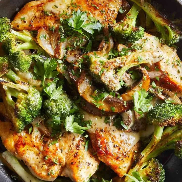 Mushroom topped chicken cutlets served on a plate with herbs and spices