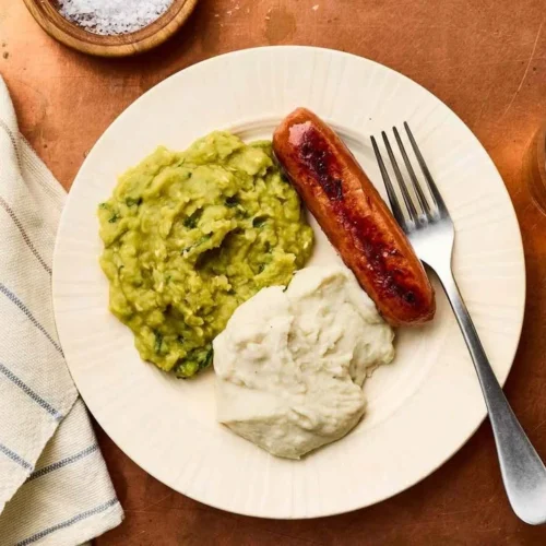 Bowl of creamy mushy peas served as a side dish.