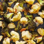 Plate of roasted broccoli and cauliflower with spices and olive oil.
