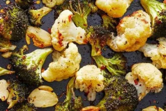 Plate of roasted broccoli and cauliflower with spices and olive oil.