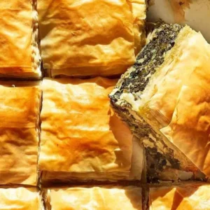 Homemade spinach pie baked to golden perfection with flaky crust.