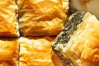 Homemade spinach pie baked to golden perfection with flaky crust.