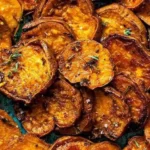 Savory sweet potatoes with earthy herbs and spices, beautifully plated.