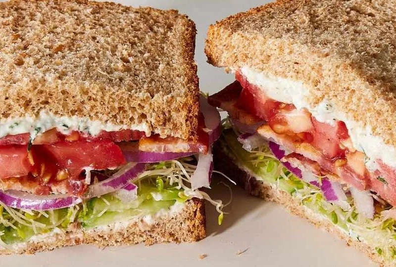 Delicious Tomato Cucumber Sandwich on a plate with fresh ingredients