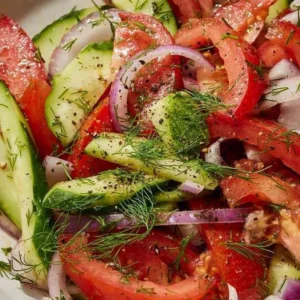 A colorful Tomato-Cucumber Salad featuring fresh tomatoes and cucumbers.