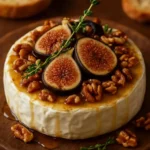 Warm Baked Brie topped with figs, honey, and pecans on a rustic platter