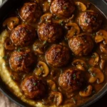Beef meatballs with onion mushroom gravy served over mashed potatoes.