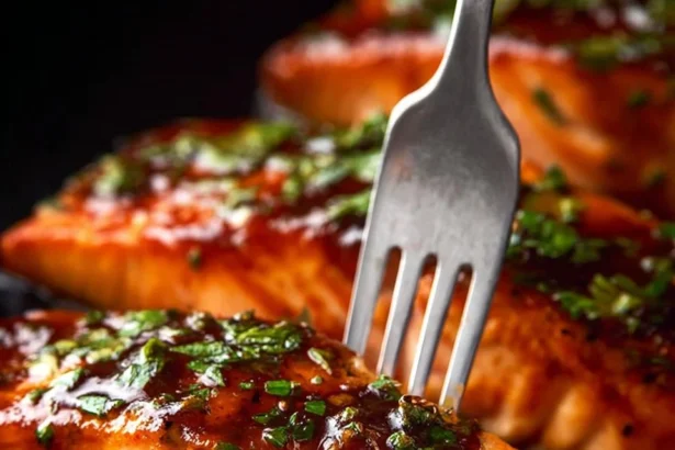 Delicious Garlic Butter Lemon Salmon served on a plate with lemon wedges