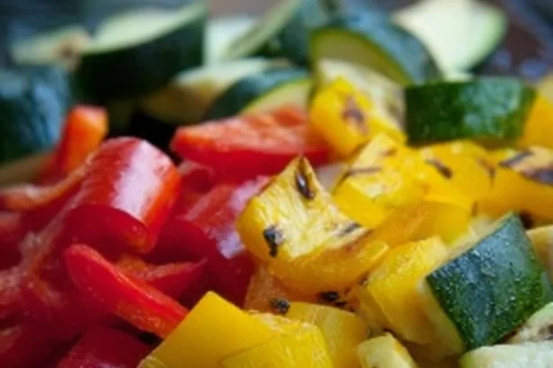 Colorful grilled vegetable salad with assorted fresh veggies served in a bowl.