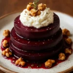Layered beets and goat cheese with walnut-thyme drizzle presentation