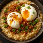 Savory oatmeal bowl with poached eggs, ginger, and sesame on top.