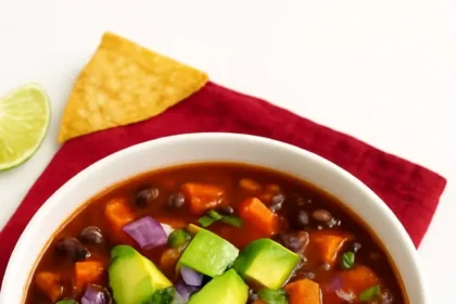 Bowl of 5-Ingredient Sweet Potato Black Bean Chili garnished with herbs