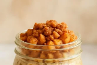 Bowl of apple pie overnight oats topped with apple slices and cinnamon