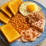 Beans on toast topped with tuna, prawns, cheese, and a fried egg