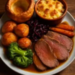 A deliciously plated beef dinner with sides in a cozy dining setting.