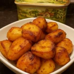 Golden beef dripping roasted potatoes served on a plate.