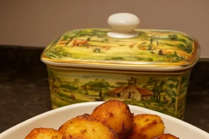 Golden beef dripping roasted potatoes served on a plate.