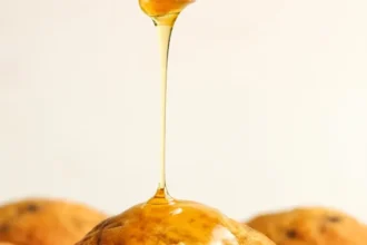 Freshly baked Blackberry Cornmeal Muffins on a wooden platter