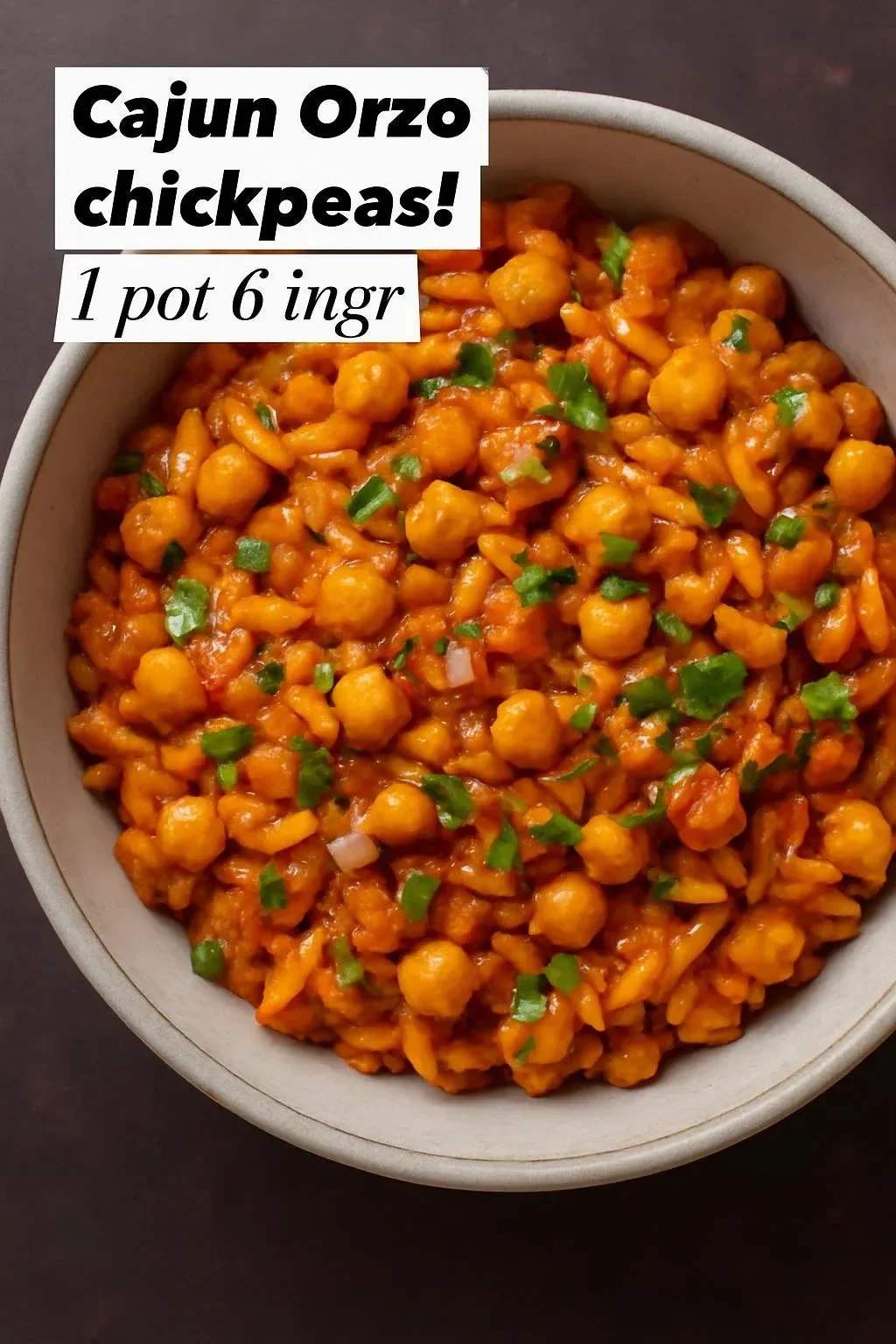 Cajun Spiced Orzo with Chickpeas garnished with herbs in a bowl.