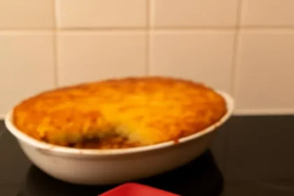 Delicious Cottage Pie served in a rustic dish, showcasing layers of meat and mashed potatoes.