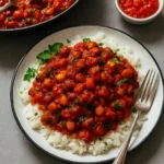 Bowl of Eggplant Tomato Stew garnished with fresh herbs