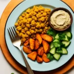 Fluffy chickpea scramble served on a plate with fresh herbs and vegetables.