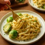Garlic pasta with white wine and roasted Brussels sprouts served in a bowl.