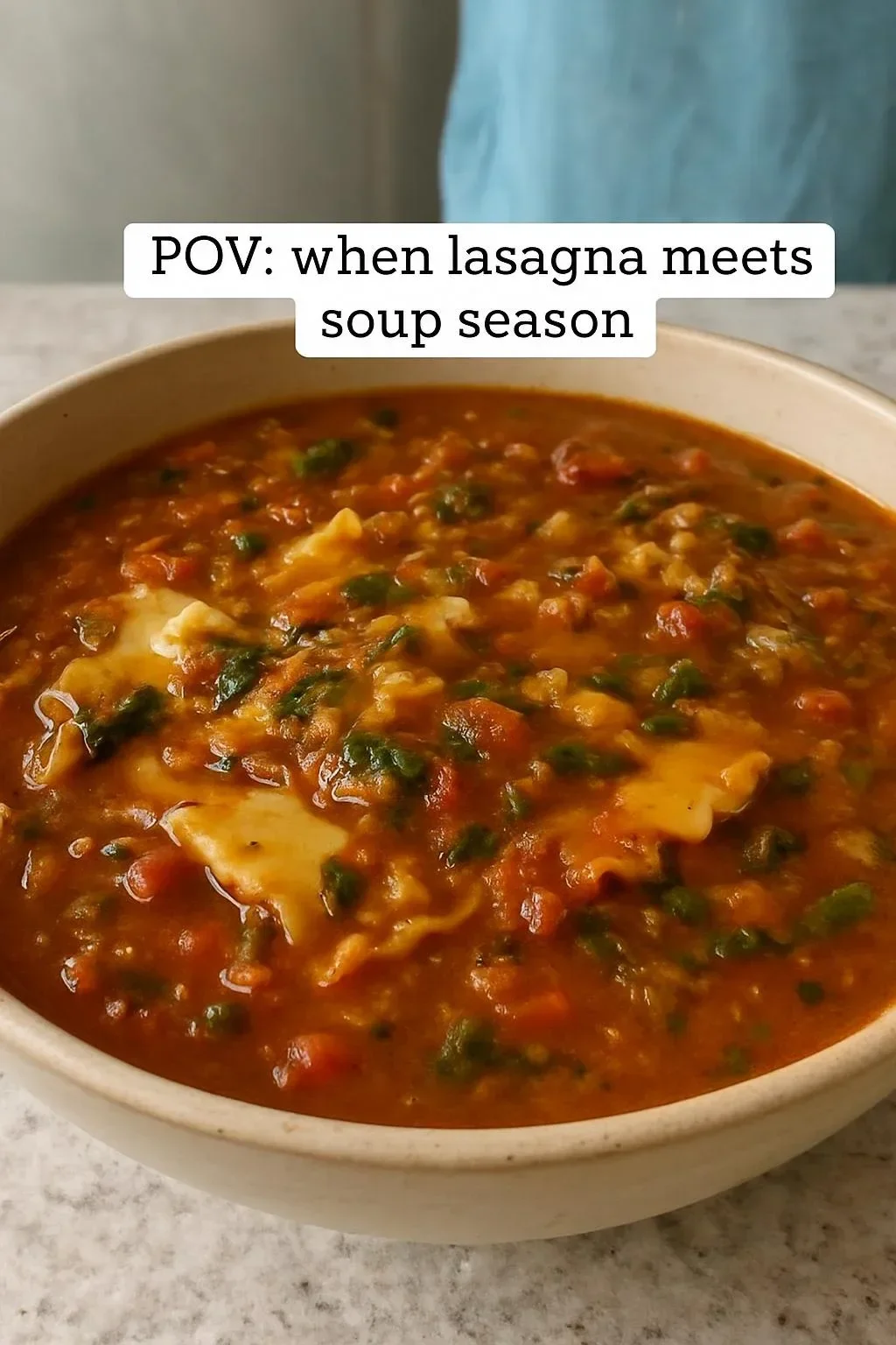 Bowl of Instant Pot Lasagna Soup topped with cheese and herbs