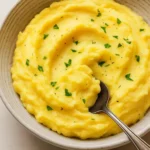 Delicious Instant Pot mashed potatoes topped with butter and herbs