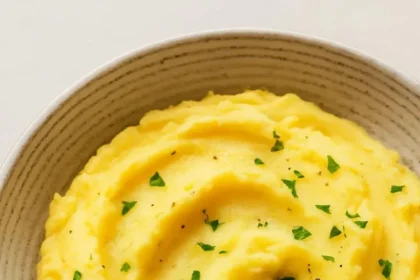 Delicious Instant Pot mashed potatoes topped with butter and herbs