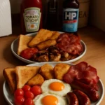 Delicious Sunday fry-up featuring eggs, bacon, sausages, and toast