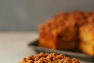 Slice of Pumpkin Coffee Cake on a plate with coffee