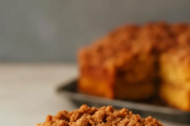 Slice of Pumpkin Coffee Cake on a plate with coffee